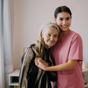 happy-caregiver-and-senior-patient-smiling-and-loo-2023-02-23-23-11-38-utc